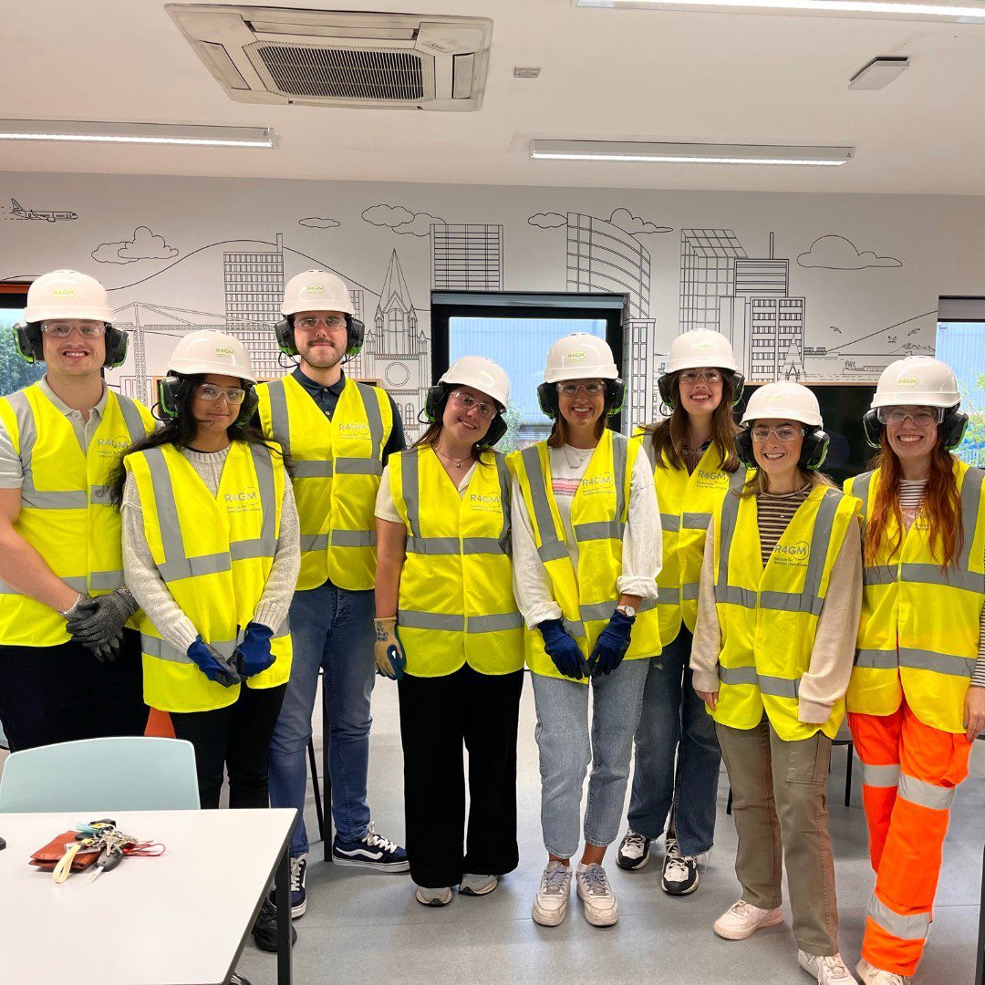 Alt='People stood in hard hats and reflective vests'